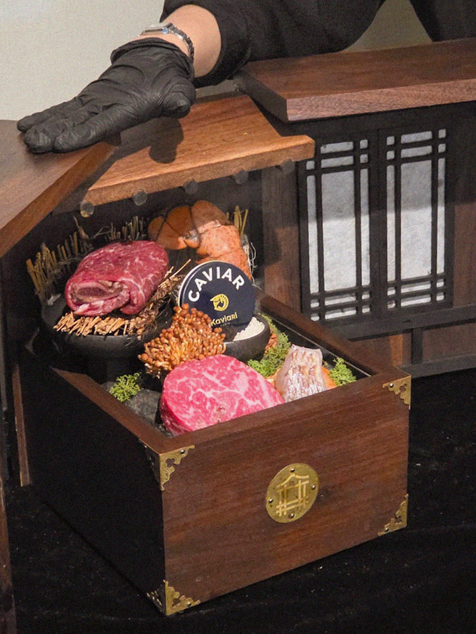DAEBOJUNG City Hall · the signature Hanwoo showing — marbled beef cuts and caviar presented in a display chest