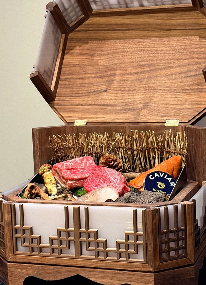 DAEBOJUNG Yeouido · the signature Hanwoo showing — marbled beef cuts and caviar presented in a display chest