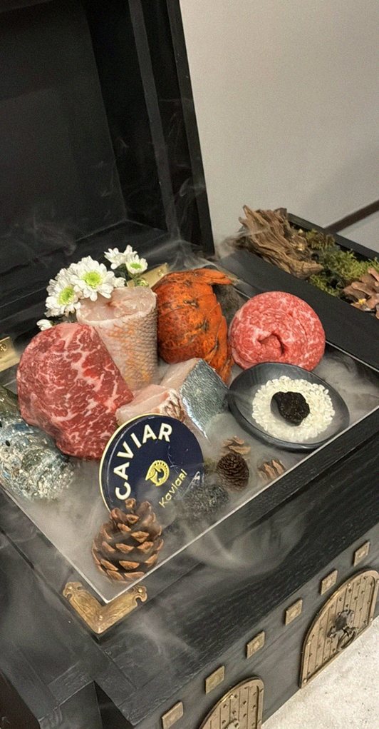 GOWOOGA Gwanghwamun · the signature Hanwoo showing — marbled beef cuts and caviar presented in a display chest