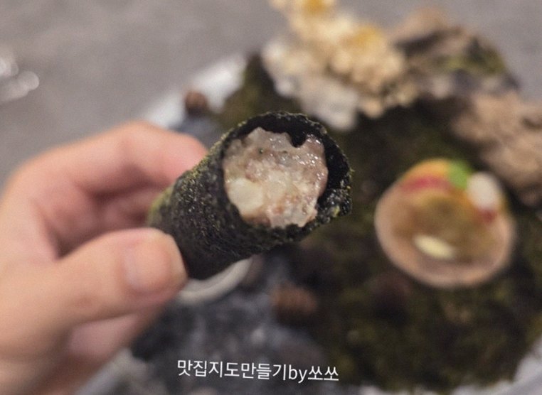GOWOOGA Gwanghwamun · the signature Hanwoo showing — marbled beef cuts and caviar presented in a display chest