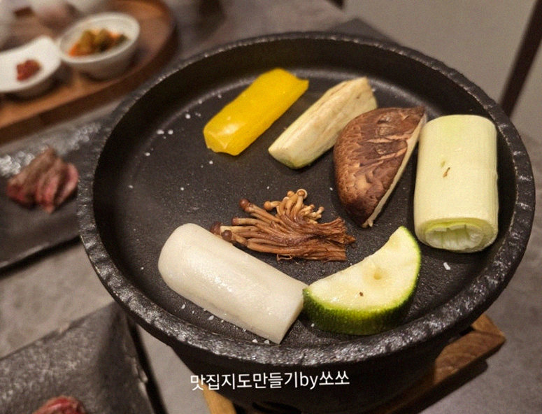 GOWOOGA Gwanghwamun · the signature Hanwoo showing — marbled beef cuts and caviar presented in a display chest