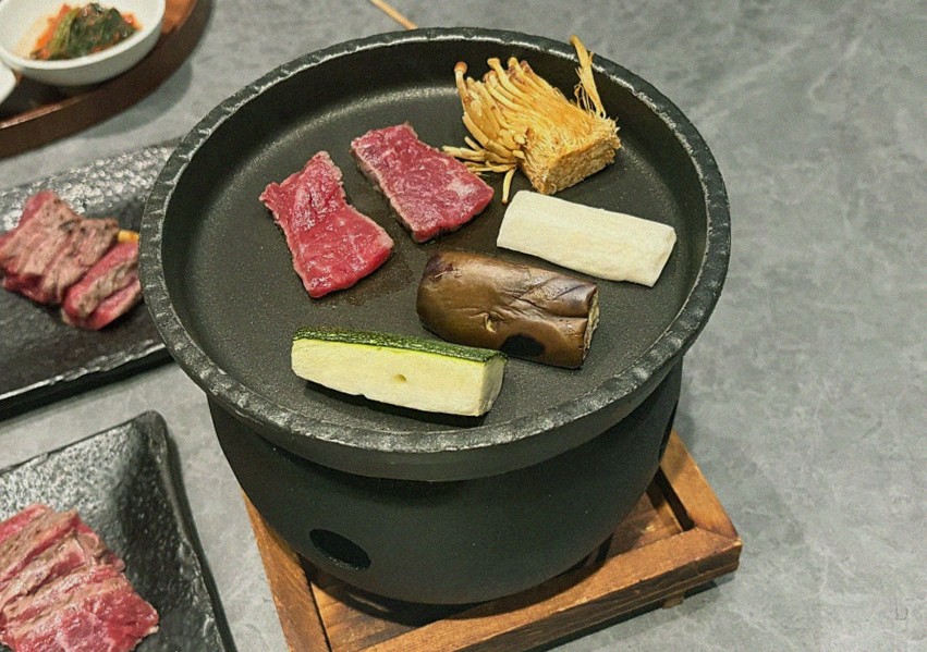 GOWOOGA Gangnam·Yeoksam · the signature Hanwoo showing — marbled beef cuts and caviar presented in a display chest