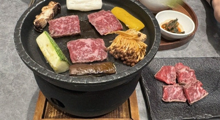 GOWOOGA Gangnam·Yeoksam · the signature Hanwoo showing — marbled beef cuts and caviar presented in a display chest