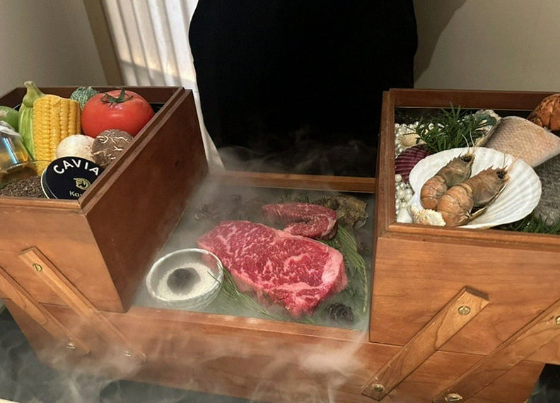 WOOARA Gwanghwamun · the signature Hanwoo showing — marbled beef cuts and caviar presented in a display chest