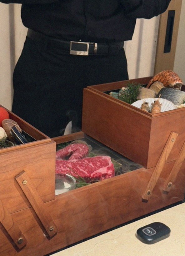 WOOARA Gwanghwamun · the signature Hanwoo showing — marbled beef cuts and caviar presented in a display chest