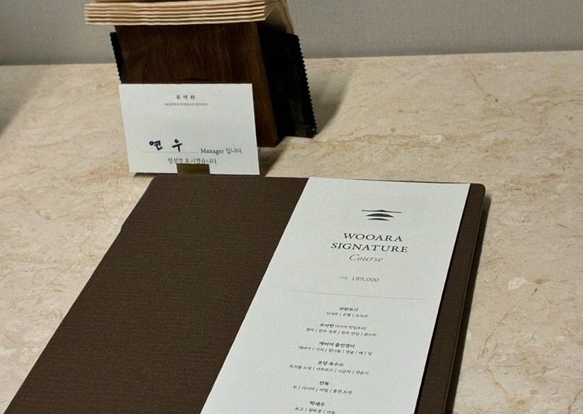 WOOARA Yeouido · the signature Hanwoo showing — marbled beef cuts and caviar presented in a display chest
