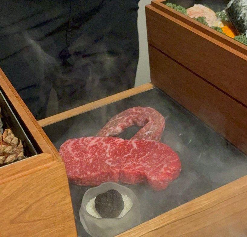 WOOARA Yeouido · the signature Hanwoo showing — marbled beef cuts and caviar presented in a display chest