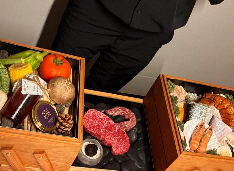 WOOARA Yeouido · the signature Hanwoo showing — marbled beef cuts and caviar presented in a display chest
