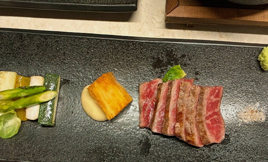 WOOARA Yeouido · the signature Hanwoo showing — marbled beef cuts and caviar presented in a display chest