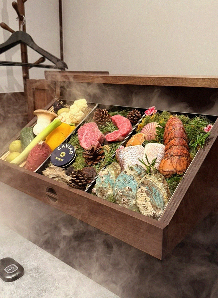 WOOHANA Jonggak · the signature Hanwoo showing — marbled beef cuts and caviar presented in a display chest