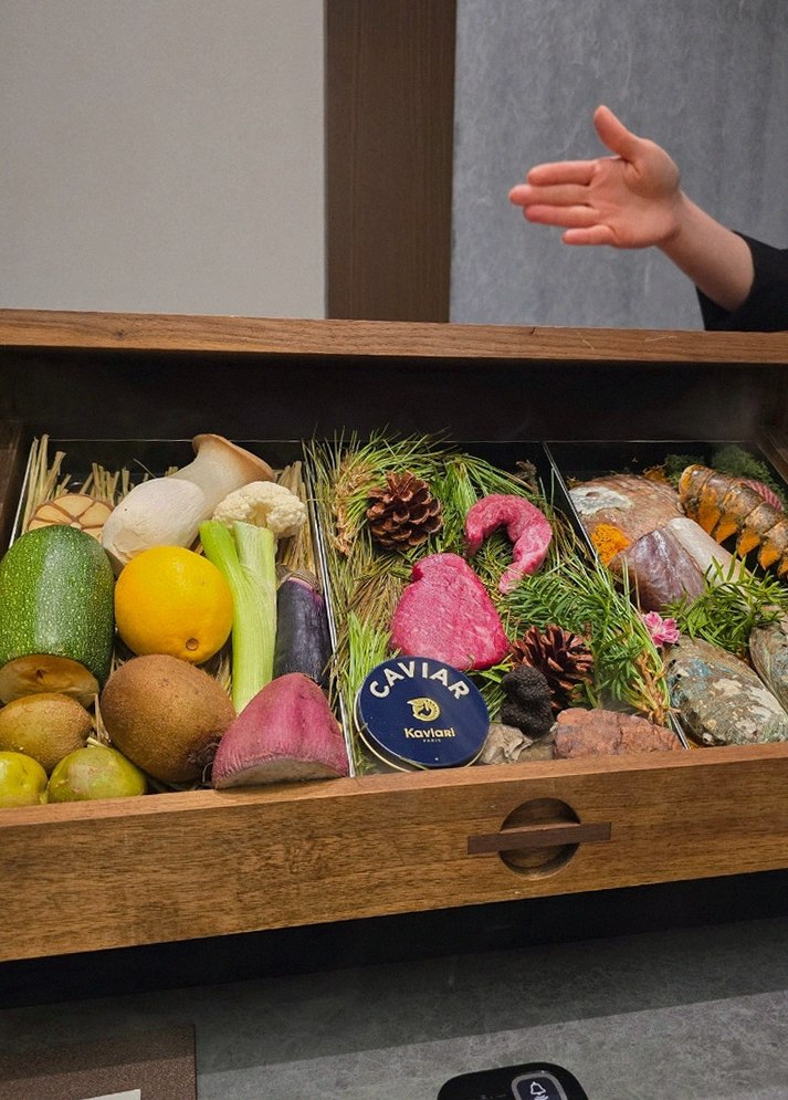 WOOHANA Yeouido · the signature Hanwoo showing — marbled beef cuts and caviar presented in a display chest