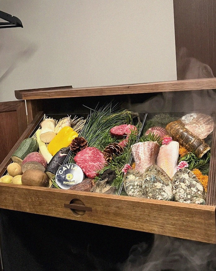 WOOHANA Yeouido · the signature Hanwoo showing — marbled beef cuts and caviar presented in a display chest