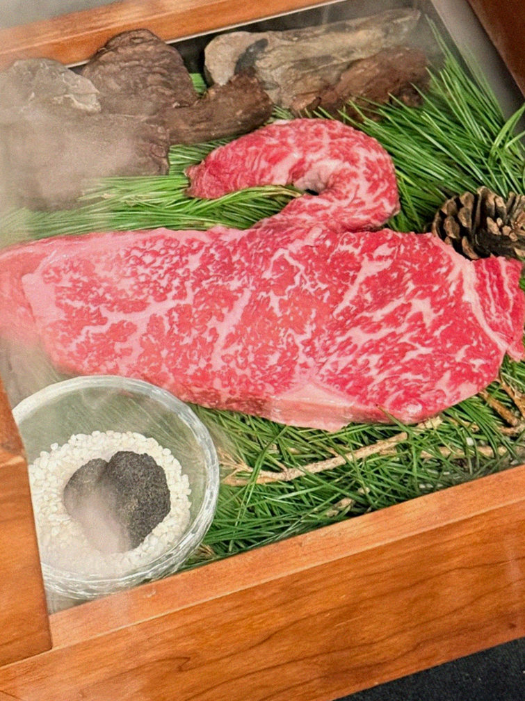 WOOARA Yeouido · the signature Hanwoo showing — marbled beef cuts and caviar presented in a display chest