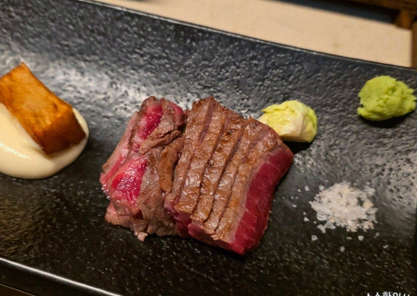 WOOARA Yeouido · the signature Hanwoo showing — marbled beef cuts and caviar presented in a display chest