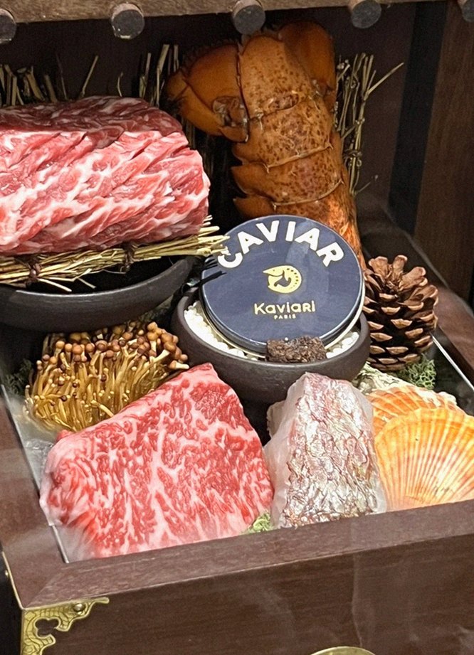 DAEBOJUNG Yeouido · the signature Hanwoo showing — marbled beef cuts and caviar presented in a display chest