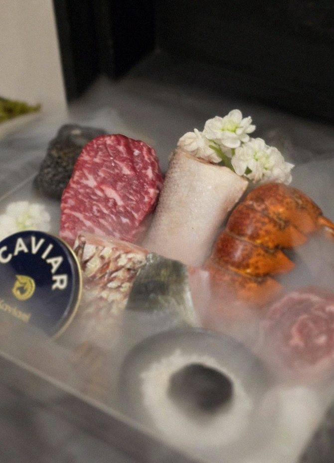 GOWOOGA Gwanghwamun · the signature Hanwoo showing — marbled beef cuts and caviar presented in a display chest