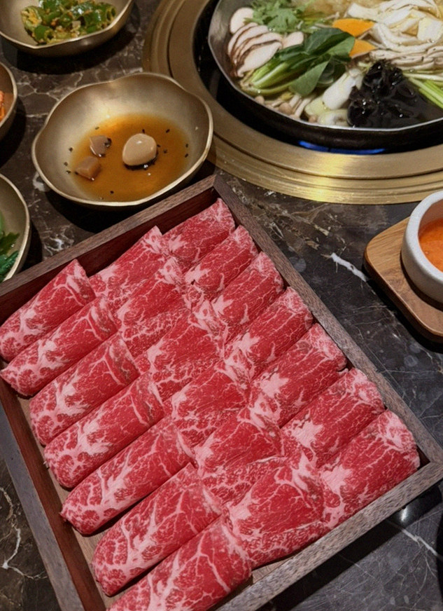 DAEBOJUNG City Hall · the signature Hanwoo showing — marbled beef cuts and caviar presented in a display chest