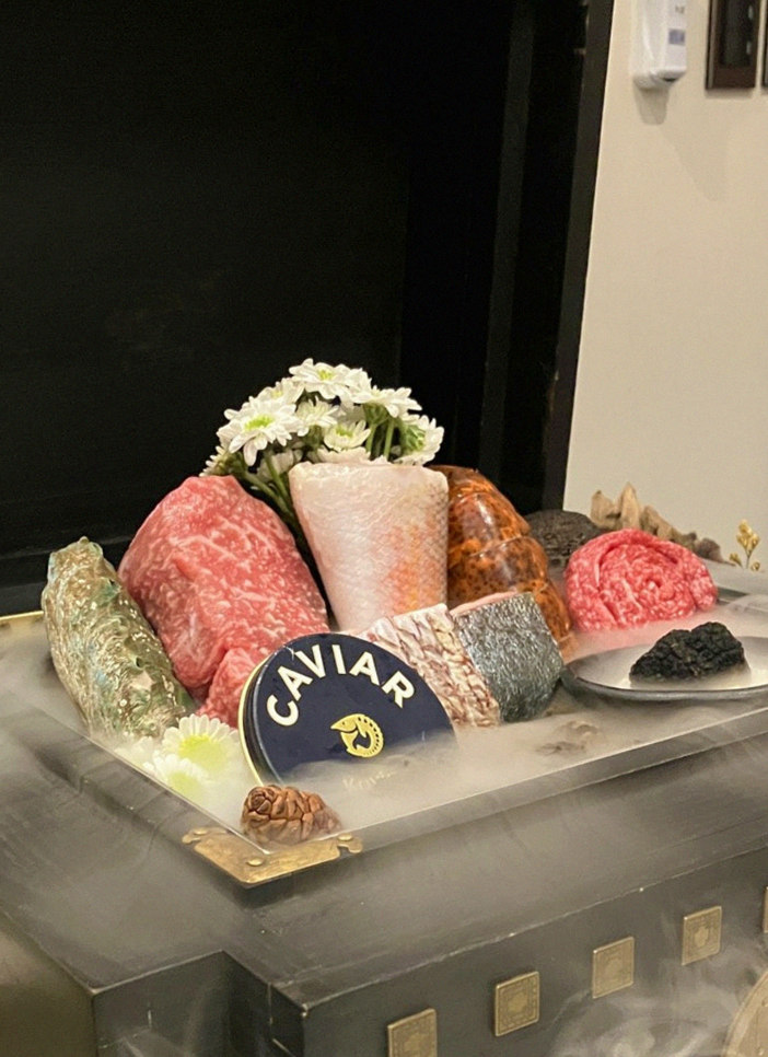 GOWOOGA Gwanghwamun · the signature Hanwoo showing — marbled beef cuts and caviar presented in a display chest
