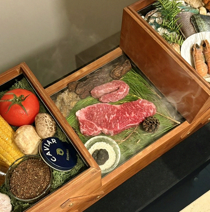 WOOARA Yeouido · the signature Hanwoo showing — marbled beef cuts and caviar presented in a display chest