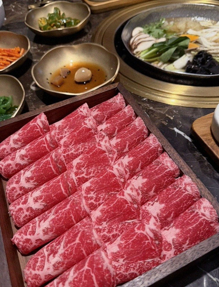DAEBOJUNG City Hall · the signature Hanwoo showing — marbled beef cuts and caviar presented in a display chest