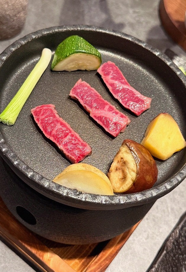 WOOHANA Yeouido · the signature Hanwoo showing — marbled beef cuts and caviar presented in a display chest
