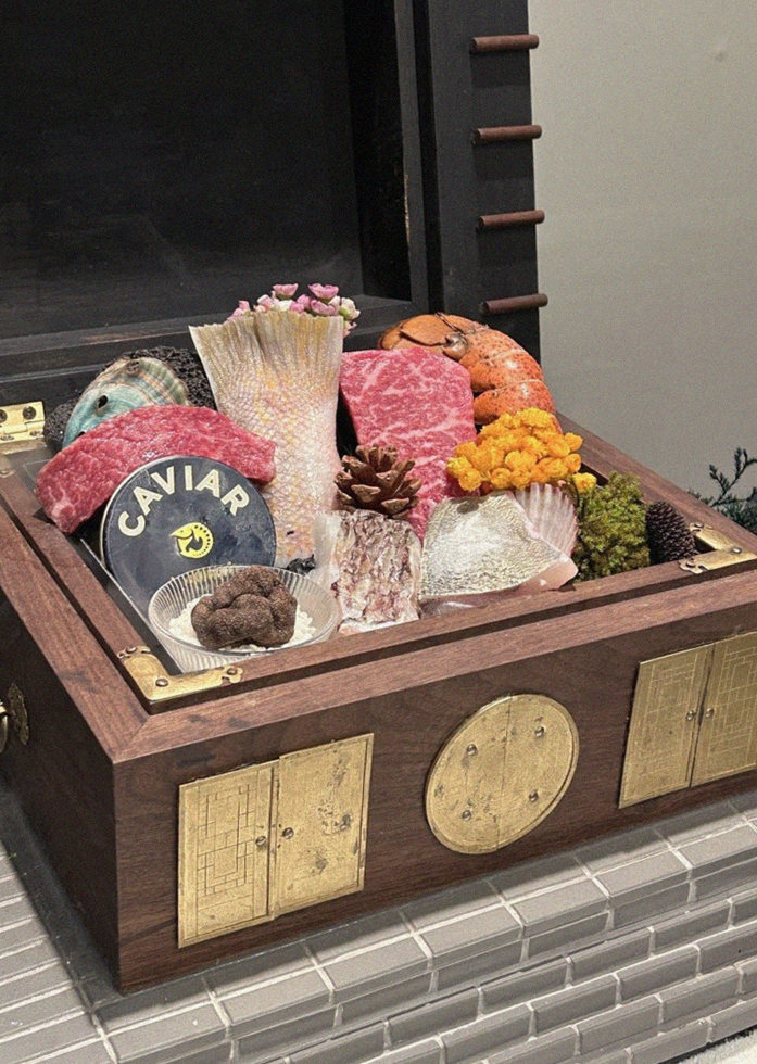 GOWOOGA Yeouido · the signature Hanwoo showing — marbled beef cuts and caviar presented in a display chest