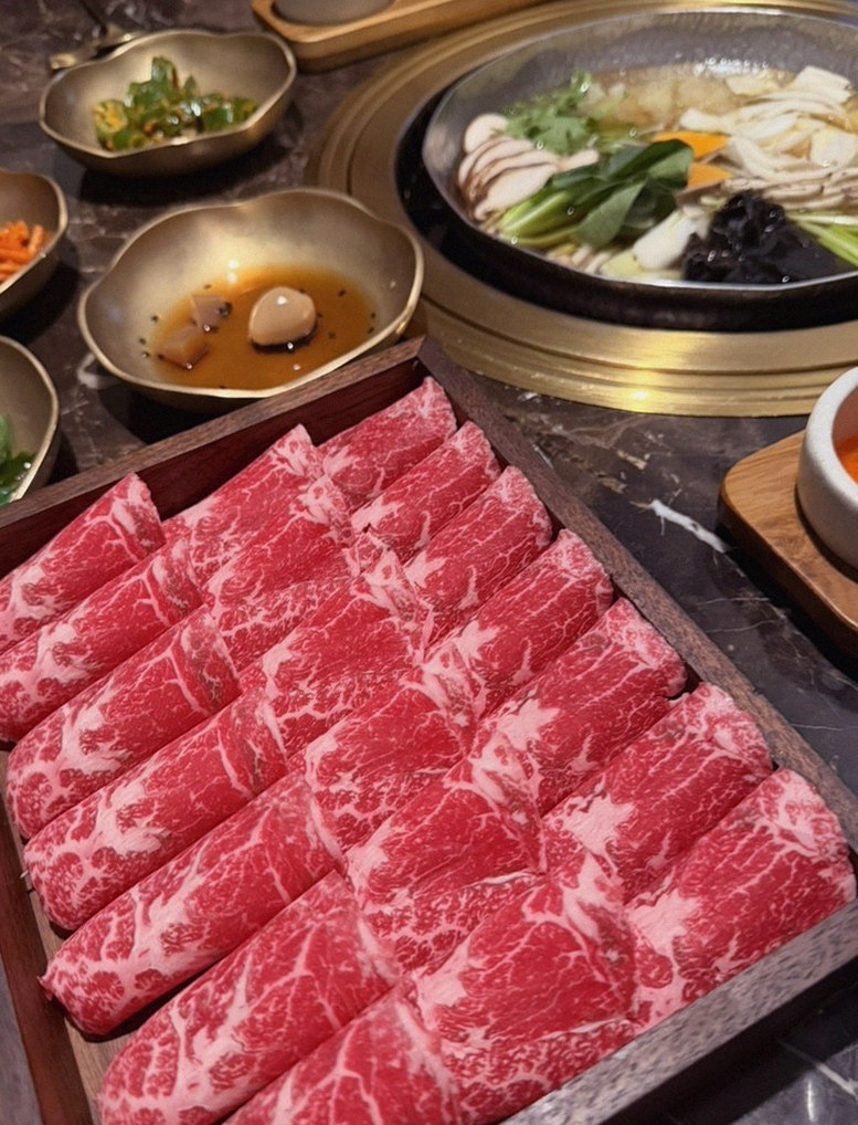 DAEBOJUNG Yeouido · the signature Hanwoo showing — marbled beef cuts and caviar presented in a display chest