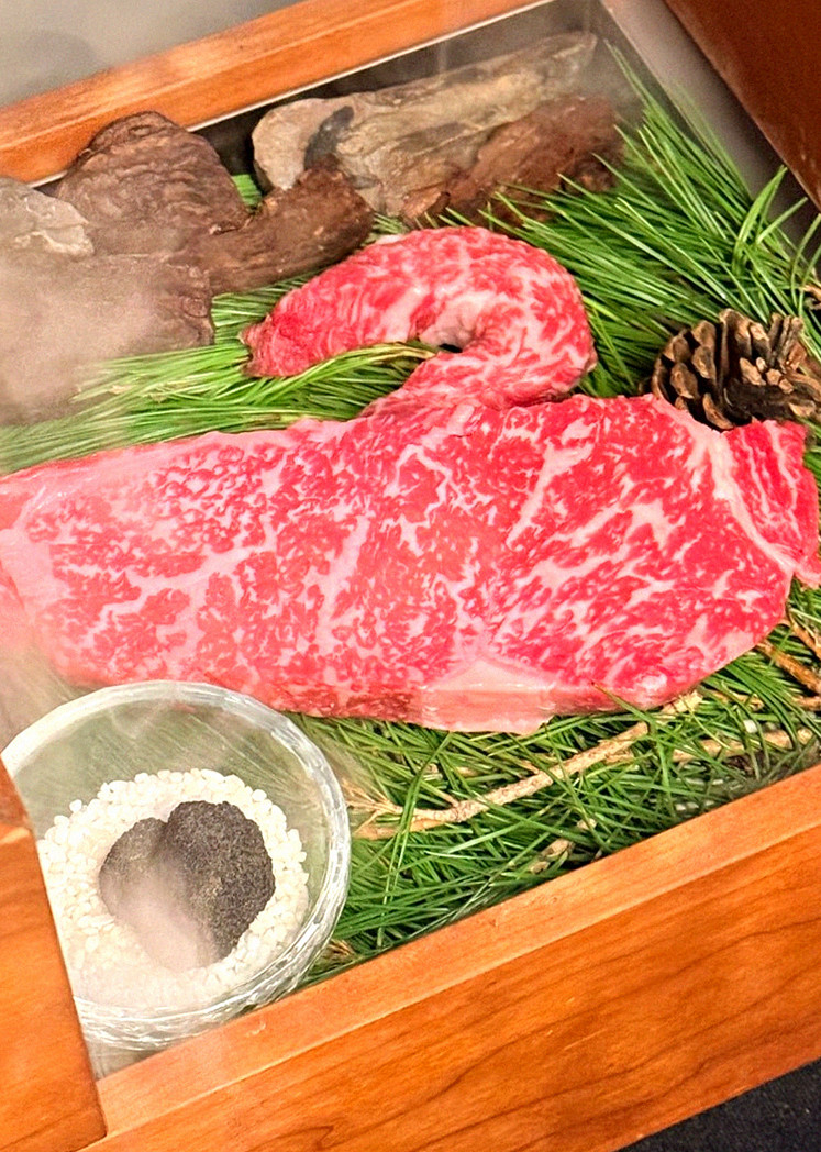 WOOARA Yeouido · the signature Hanwoo showing — marbled beef cuts and caviar presented in a display chest