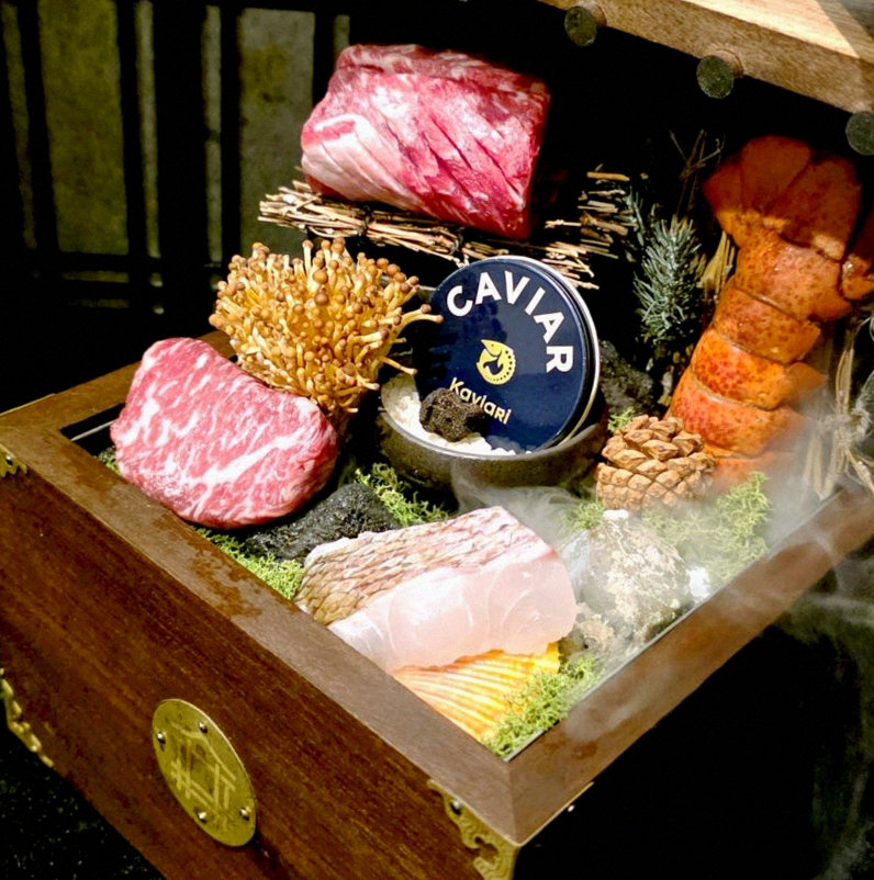 DAEBOJUNG City Hall · the signature Hanwoo showing — marbled beef cuts and caviar presented in a display chest