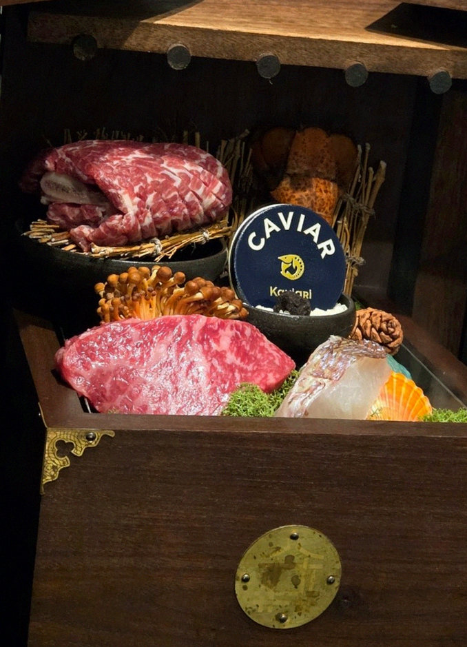 DAEBOJUNG City Hall · the signature Hanwoo showing — marbled beef cuts and caviar presented in a display chest