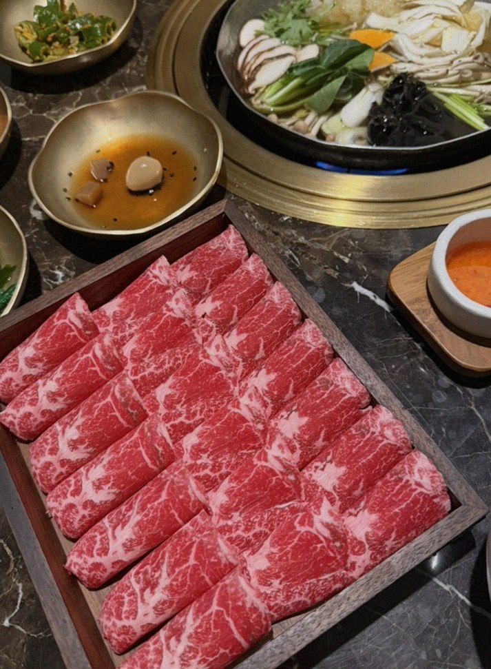 DAEBOJUNG City Hall · the signature Hanwoo showing — marbled beef cuts and caviar presented in a display chest