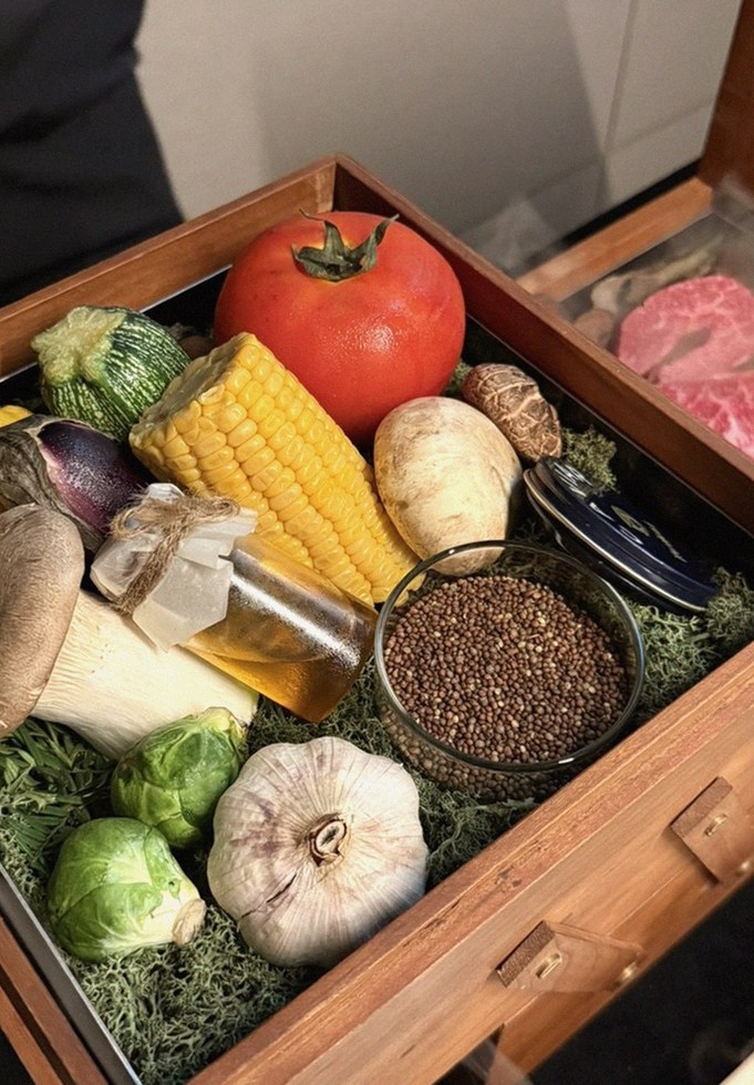 WOOARA Yeouido · the signature Hanwoo showing — marbled beef cuts and caviar presented in a display chest