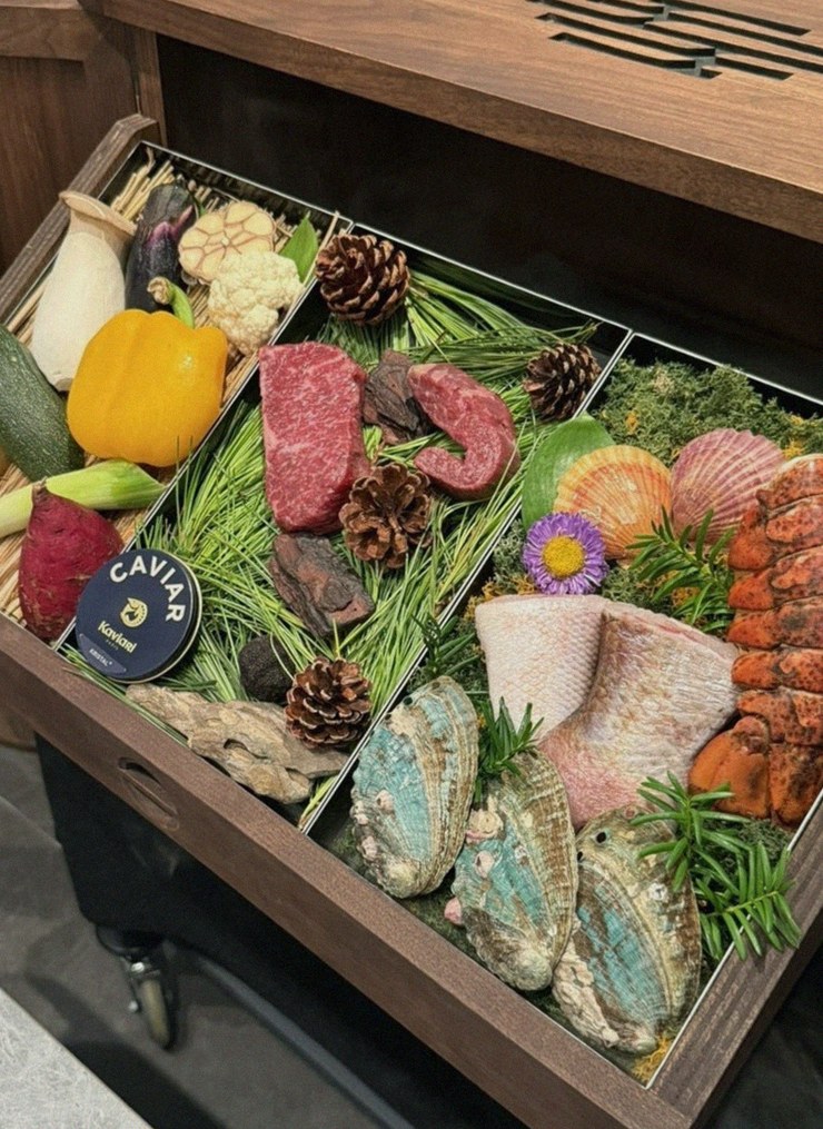 WOOHANA Jonggak · the signature Hanwoo showing — marbled beef cuts and caviar presented in a display chest
