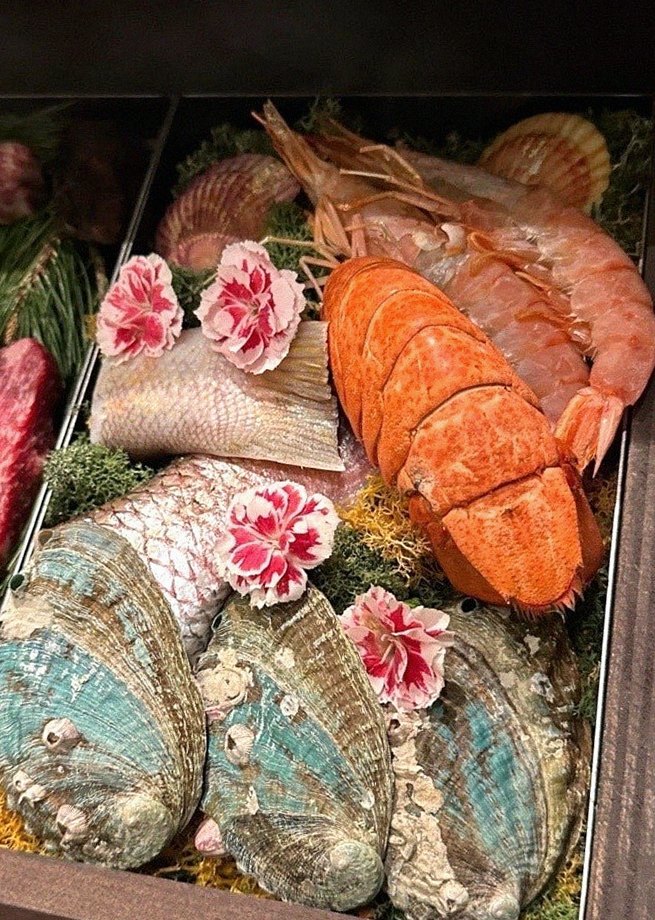 WOOHANA Jonggak · seafood course served alongside the beef