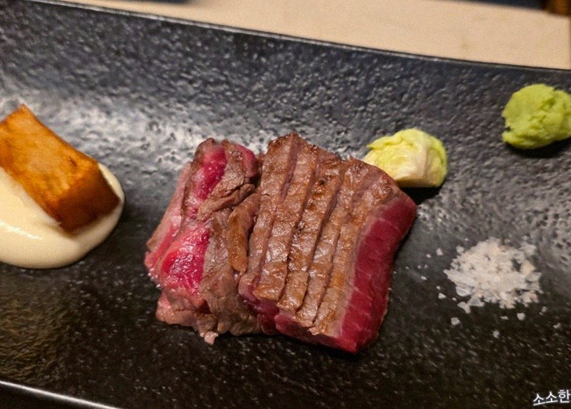 WOOARA Yeouido · the signature Hanwoo showing — marbled beef cuts and caviar presented in a display chest