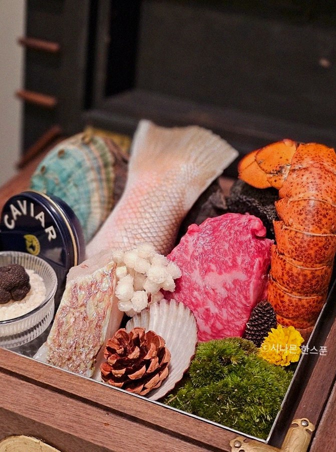 GOWOOGA Gangnam·Yeoksam · the signature Hanwoo showing — marbled beef cuts and caviar presented in a display chest