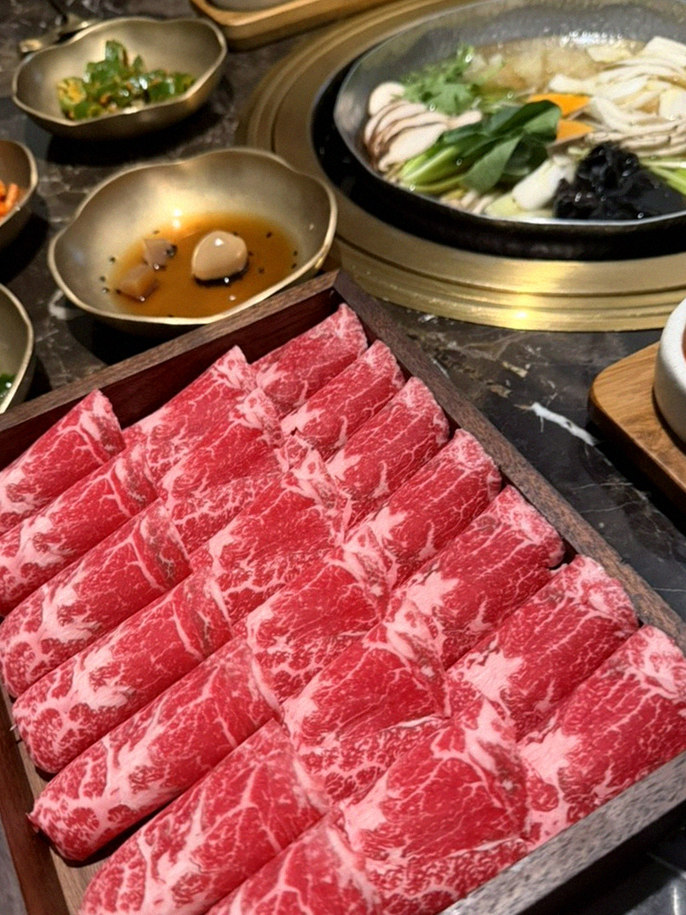 DAEBOJUNG City Hall · the signature Hanwoo showing — marbled beef cuts and caviar presented in a display chest