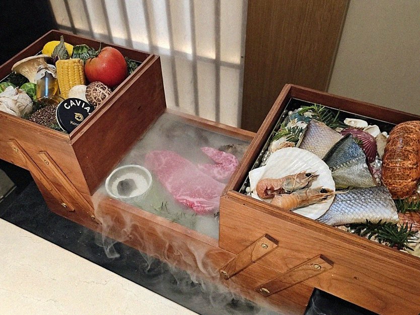 WOOARA Yeouido · the signature Hanwoo showing — marbled beef cuts and caviar presented in a display chest