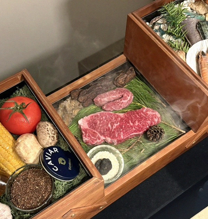WOOARA Gwanghwamun · the signature Hanwoo showing — marbled beef cuts and caviar presented in a display chest