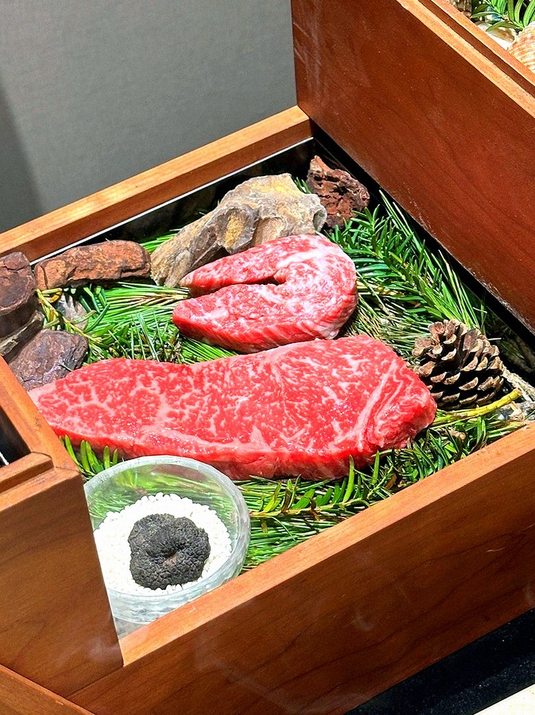 WOOARA Yeouido · the signature Hanwoo showing — marbled beef cuts and caviar presented in a display chest