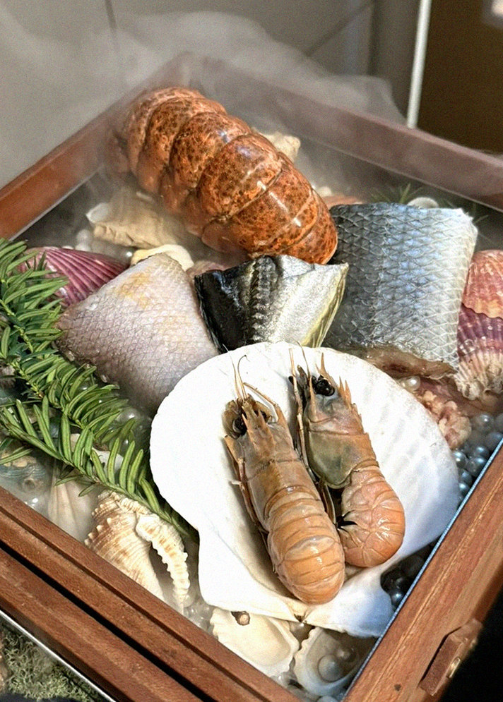 WOOARA Yeouido · the signature Hanwoo showing — marbled beef cuts and caviar presented in a display chest