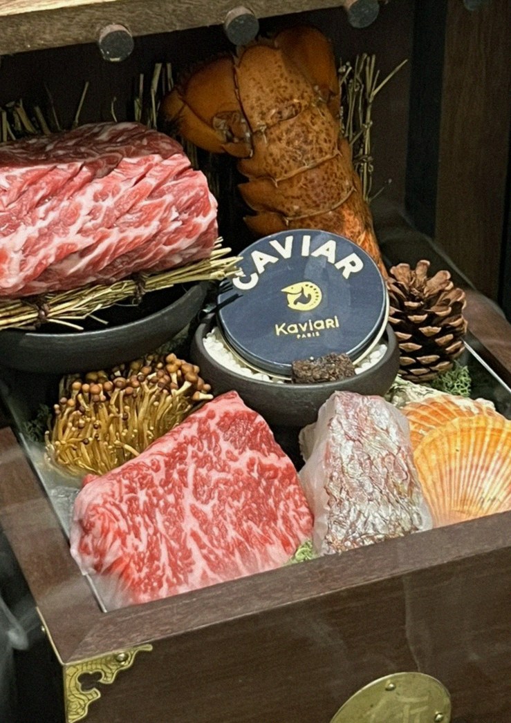 DAEBOJUNG Yeouido · the signature Hanwoo showing — marbled beef cuts and caviar presented in a display chest