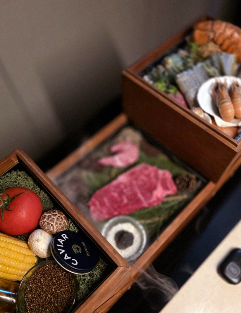 WOOARA Yeouido · the signature Hanwoo showing — marbled beef cuts and caviar presented in a display chest