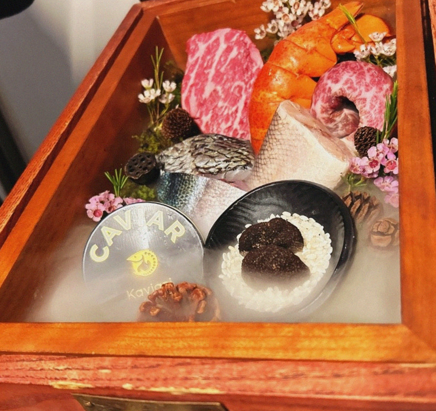 GOWOOGA Yeouido · the signature Hanwoo showing — marbled beef cuts and caviar presented in a display chest
