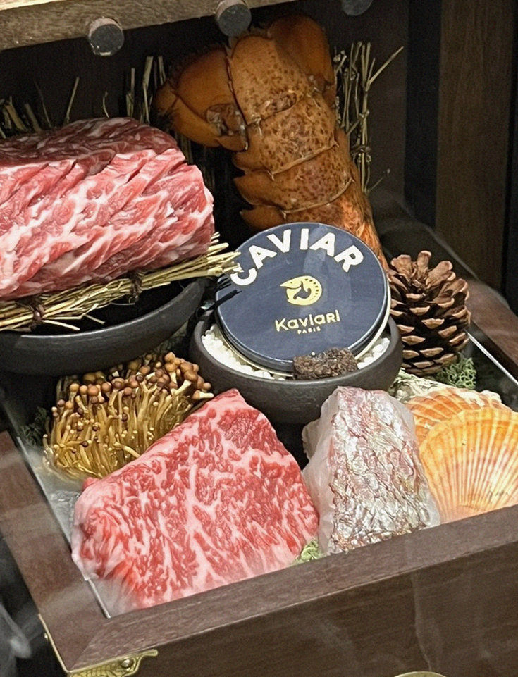 DAEBOJUNG City Hall · the signature Hanwoo showing — marbled beef cuts and caviar presented in a display chest