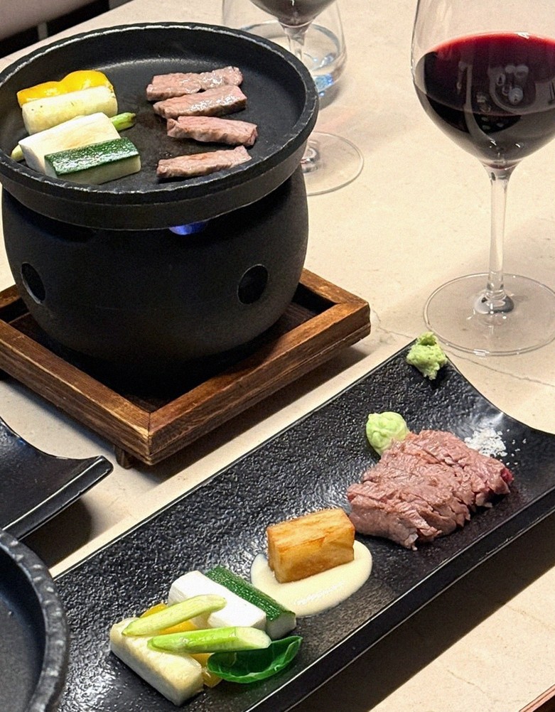WOOARA Yeouido · the signature Hanwoo showing — marbled beef cuts and caviar presented in a display chest