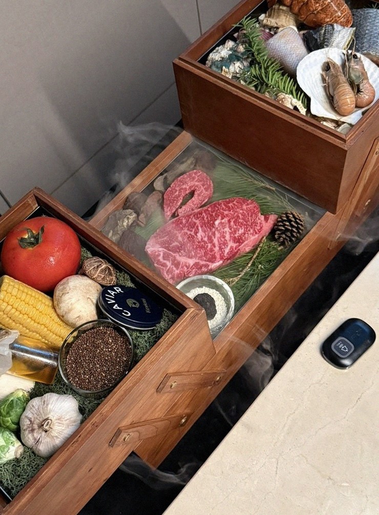WOOARA Yeouido · the signature Hanwoo showing — marbled beef cuts and caviar presented in a display chest