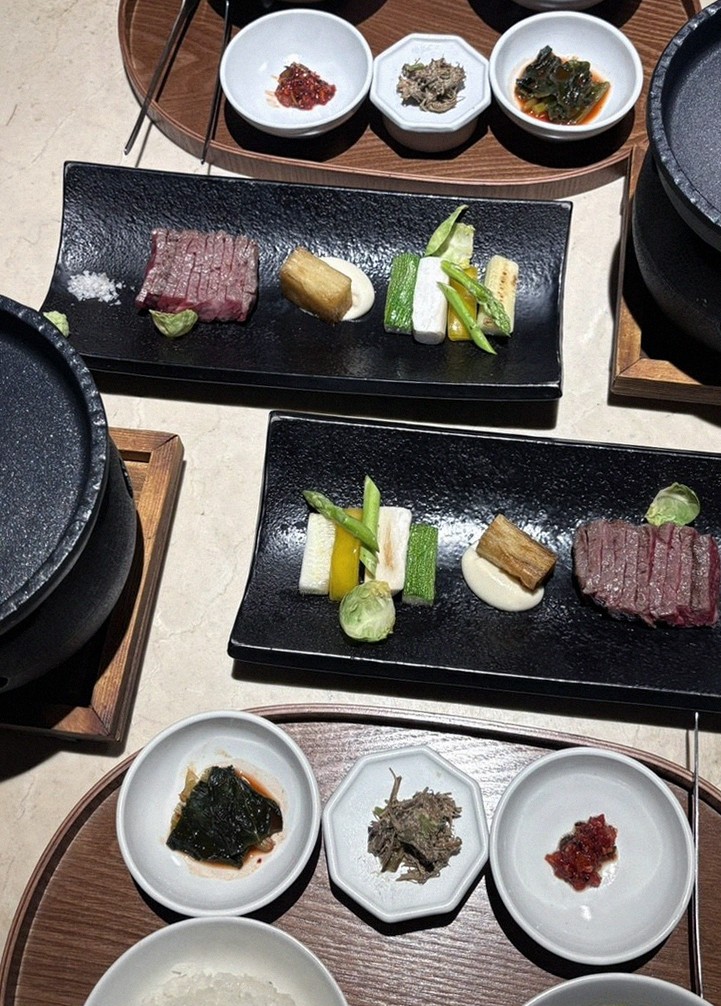 WOOARA Yeouido · the signature Hanwoo showing — marbled beef cuts and caviar presented in a display chest