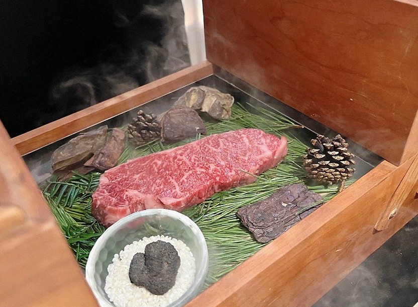 WOOARA Yeouido · the signature Hanwoo showing — marbled beef cuts and caviar presented in a display chest