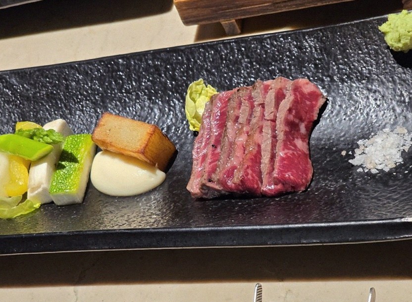 WOOARA Yeouido · the signature Hanwoo showing — marbled beef cuts and caviar presented in a display chest
